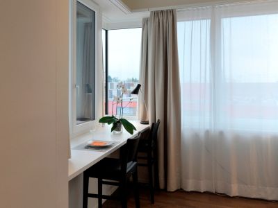 Two raised chairs, large windowsill and a lot windows