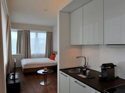 Kitchen, bed, television and a lot of windows